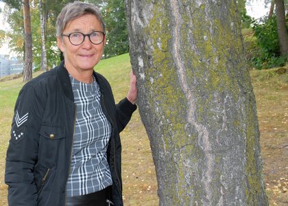 Gro Svarstad i ved et tre i en park - Klikk for stort bilde